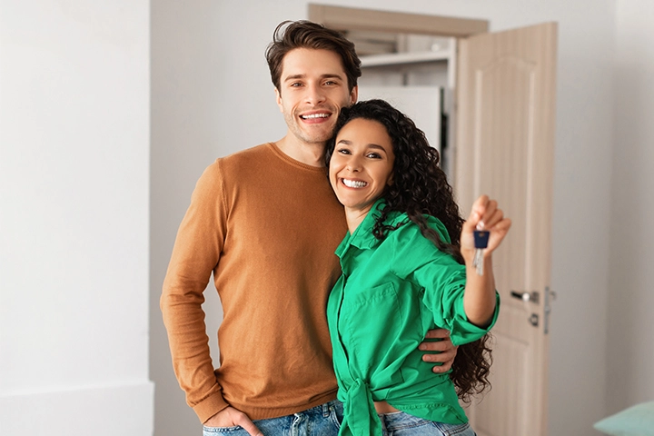 Casal jovem segurando a chave da casa nova